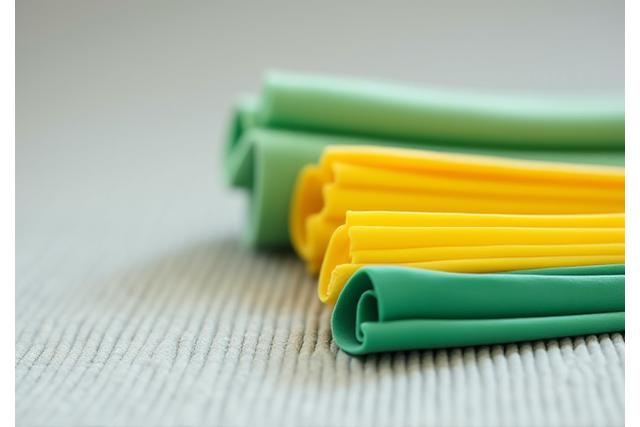 Set of colourful resistance bands neatly coiled